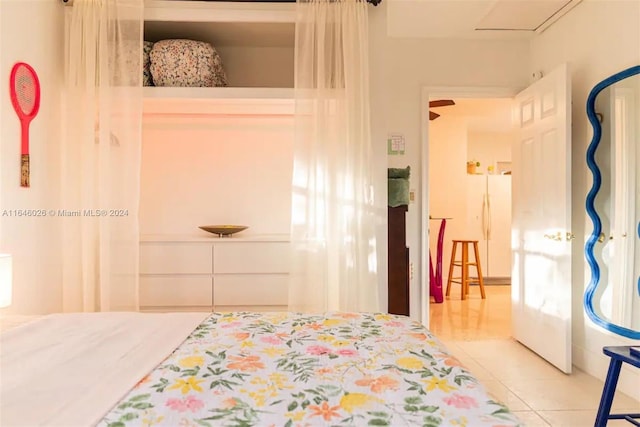 tiled bedroom featuring white refrigerator