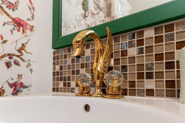 interior details featuring sink and tasteful backsplash