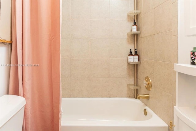 bathroom with toilet and shower / bathtub combination with curtain