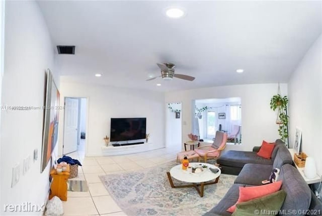 living room with ceiling fan and light tile patterned floors