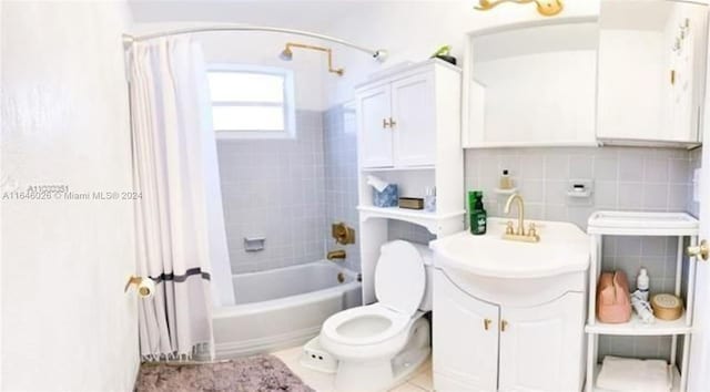 full bathroom featuring toilet, vanity, tasteful backsplash, shower / bath combo, and tile walls