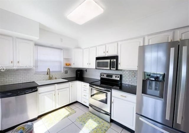 kitchen featuring white cabinetry, tasteful backsplash, sink, appliances with stainless steel finishes, and light tile patterned flooring