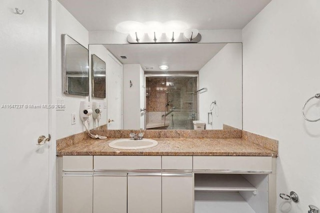 bathroom with vanity and an enclosed shower