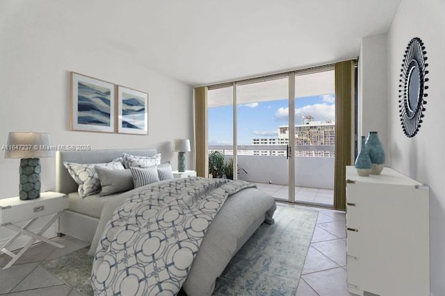 bedroom with expansive windows, light tile patterned flooring, and access to outside