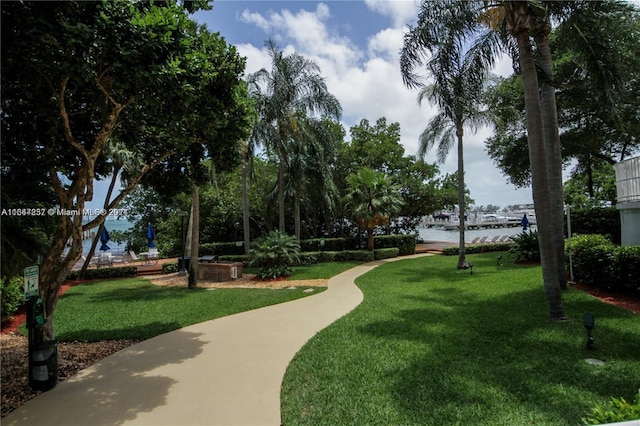 view of community with a yard and a water view