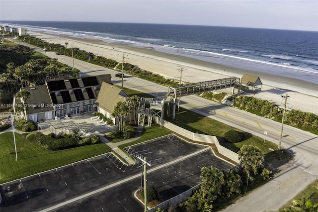 birds eye view of property featuring a beach view and a water view