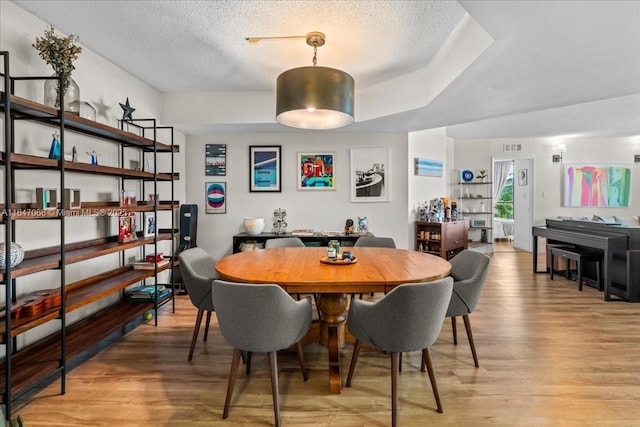 3598 Yacht Club Dr Unit 302, Aventura, FL 33180 - dining space featuring light wood-style flooring and a textured ceiling