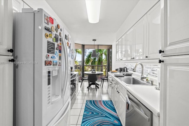 kitchen with decorative backsplash, light tile patterned flooring, a sink, white fridge with ice dispenser, and dishwasher