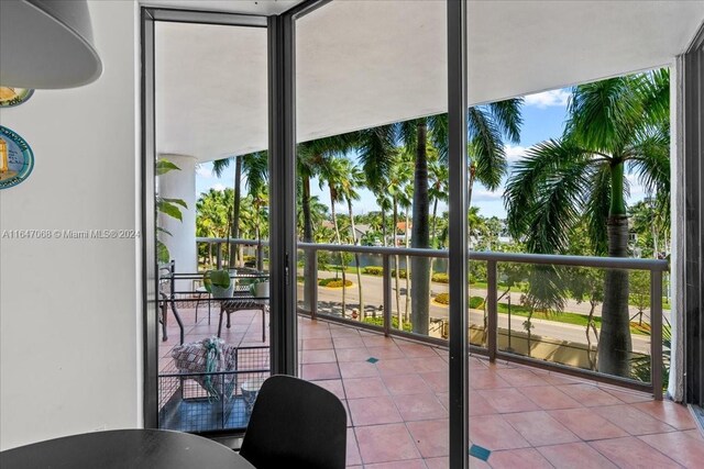 interior space with light tile patterned flooring and floor to ceiling windows