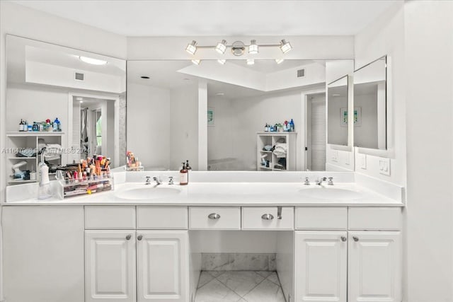 bathroom with tile patterned flooring and vanity