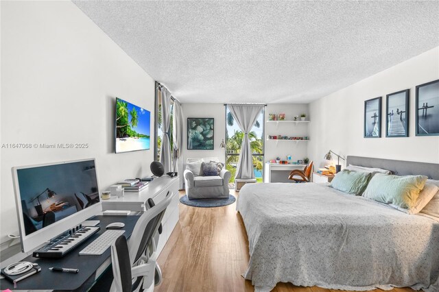 3598 Yacht Club Dr Unit 302, Aventura, FL 33180 - bedroom featuring a textured ceiling and wood finished floors