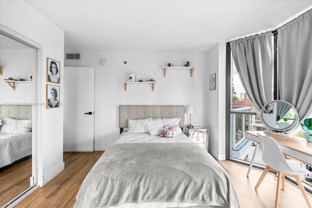 bedroom featuring light hardwood / wood-style flooring and access to exterior