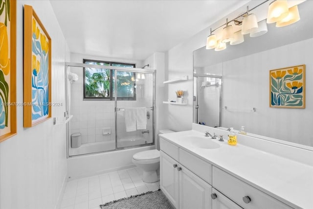 bathroom with enclosed tub / shower combo, toilet, vanity, and tile patterned floors