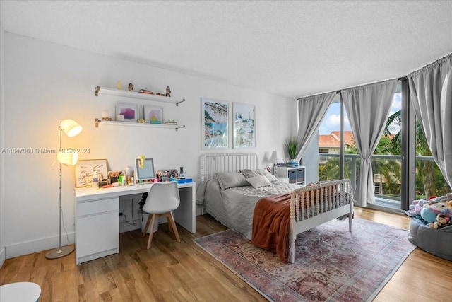 bedroom featuring light hardwood / wood-style floors and a textured ceiling