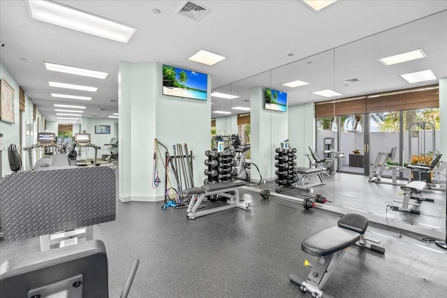 exercise room with visible vents and baseboards