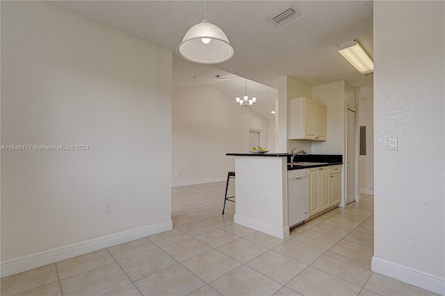 kitchen with light tile patterned floors, vaulted ceiling, a kitchen breakfast bar, and white dishwasher