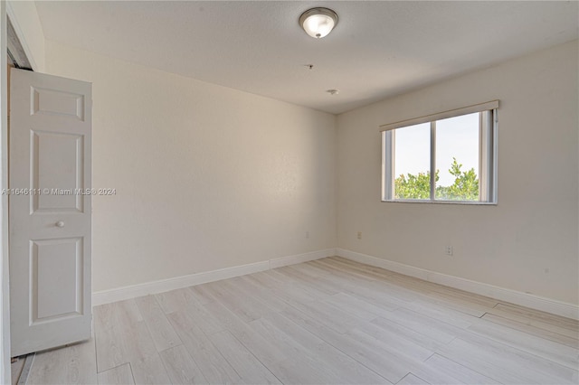 spare room featuring light hardwood / wood-style floors