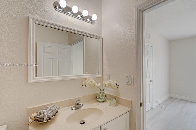 bathroom with vanity and wood-type flooring