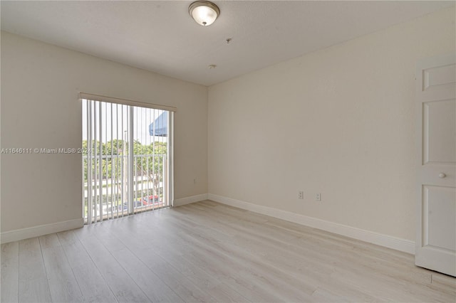 empty room with light hardwood / wood-style flooring