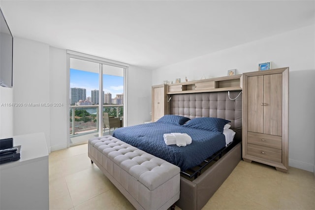 bedroom with light tile patterned flooring and floor to ceiling windows