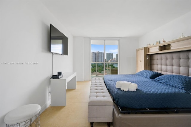 tiled bedroom featuring floor to ceiling windows