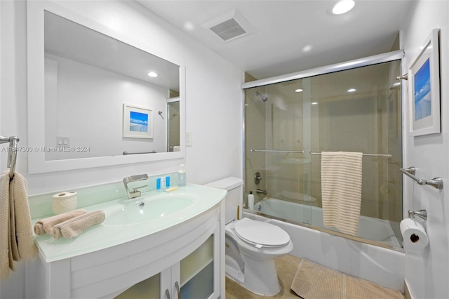 full bathroom featuring tile patterned floors, toilet, shower / bath combination with glass door, and vanity