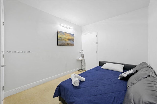 bedroom featuring light colored carpet