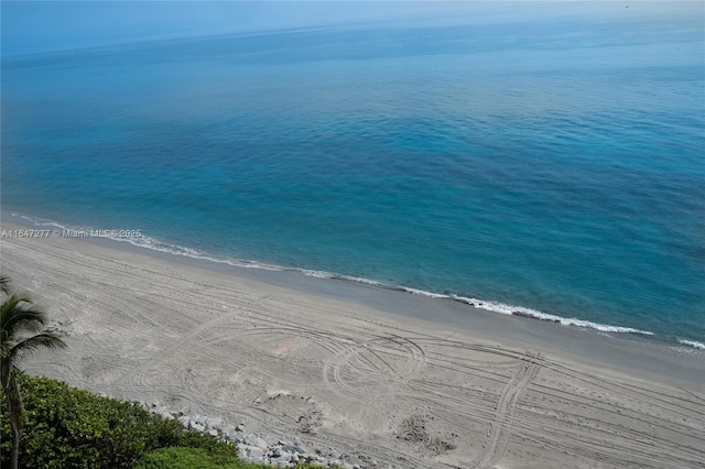 birds eye view of property featuring a water view and a view of the beach