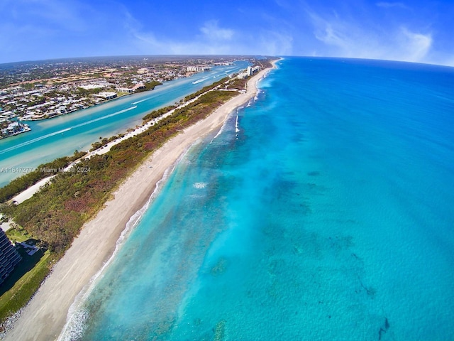 birds eye view of property featuring a view of the beach and a water view