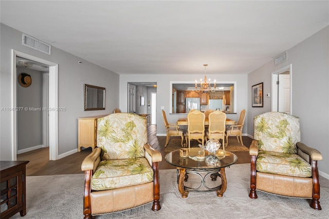 interior space with a chandelier, visible vents, and baseboards