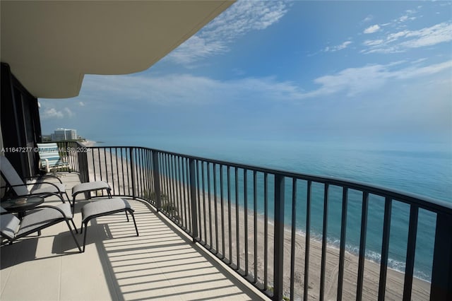 balcony with a view of the beach and a water view