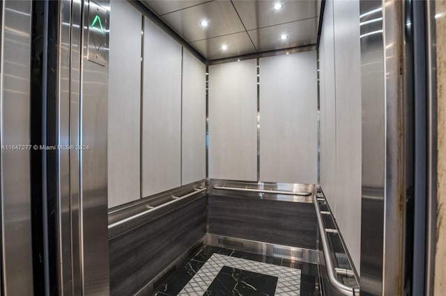 room details with elevator and tile patterned floors