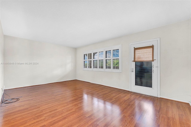 empty room with hardwood / wood-style flooring