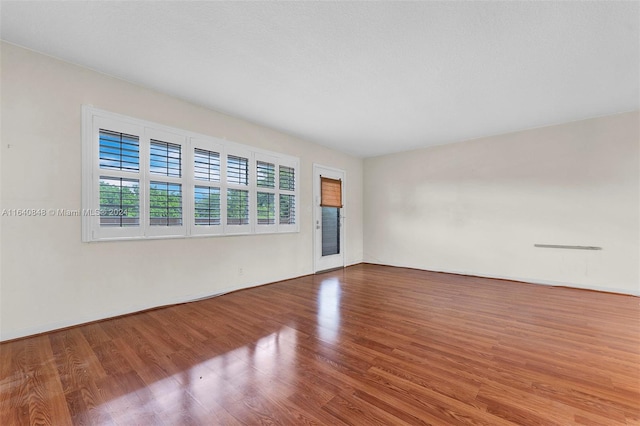 unfurnished room with wood-type flooring