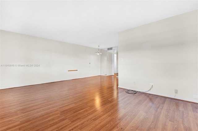 empty room with hardwood / wood-style flooring