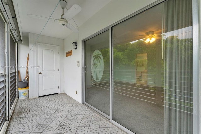 unfurnished sunroom with ceiling fan