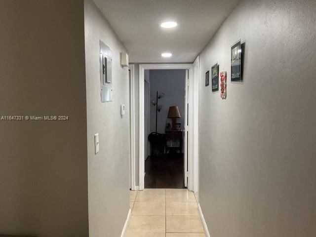 corridor featuring light tile patterned floors