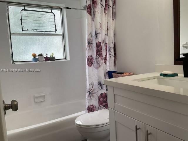 full bathroom with toilet, vanity, and shower / bathtub combination with curtain