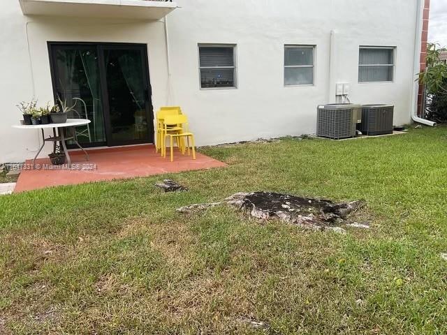 back of property featuring a patio, a yard, and cooling unit