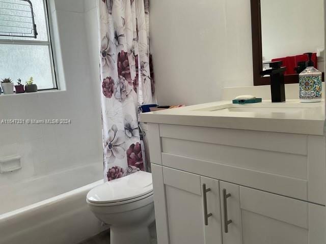 full bathroom with toilet, shower / tub combo with curtain, and vanity