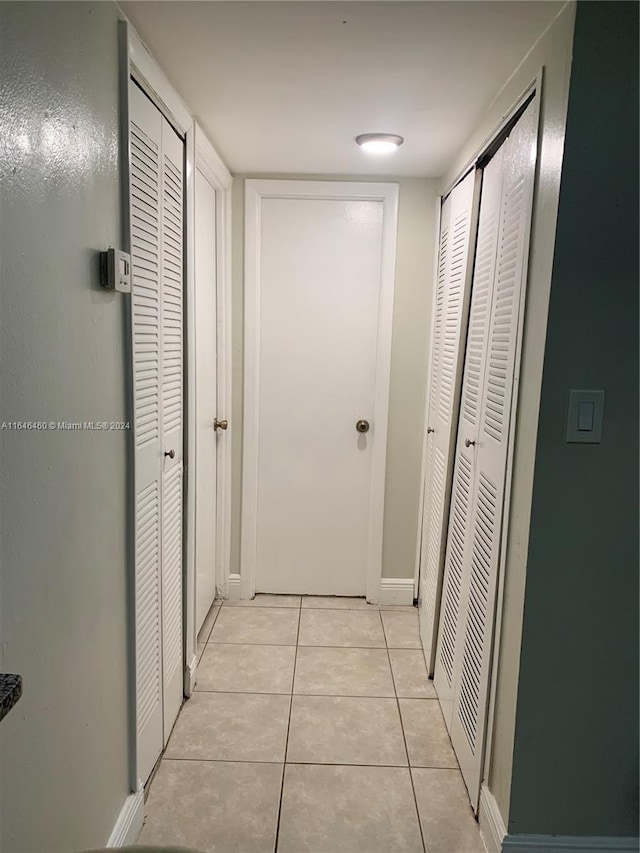 hallway featuring light tile patterned floors