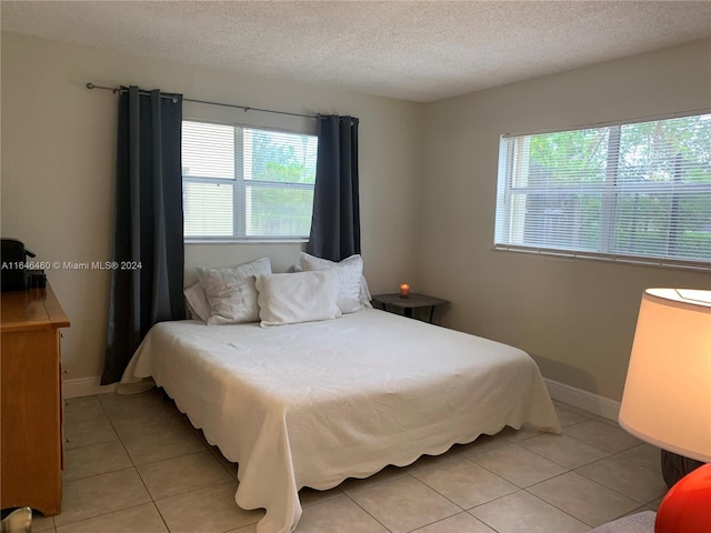 tiled bedroom with a textured ceiling