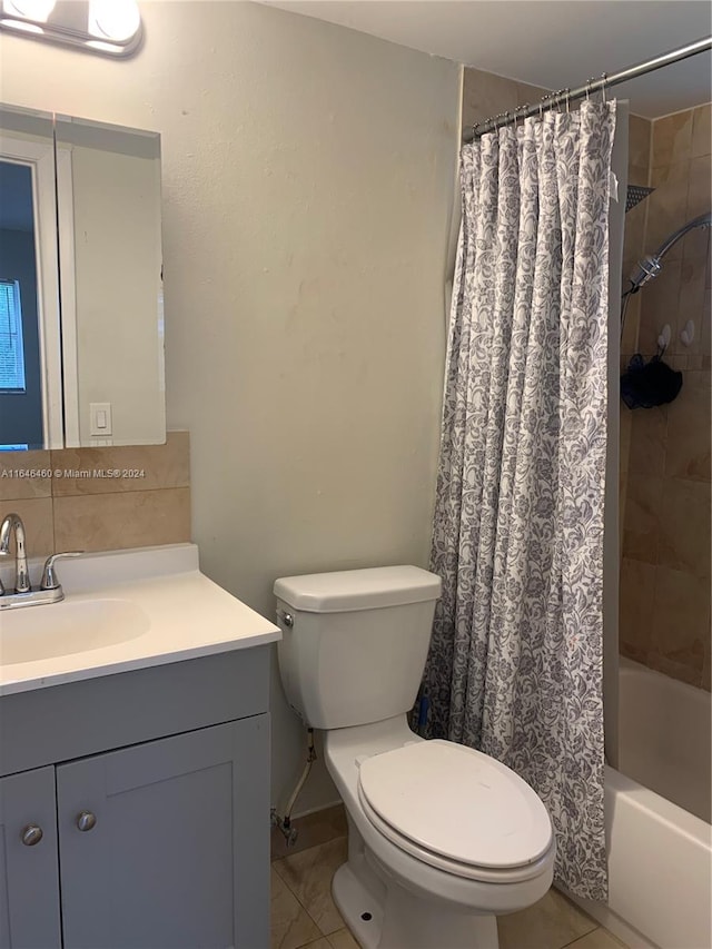 full bathroom with shower / bath combo, vanity, toilet, and tile patterned floors