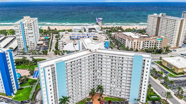 birds eye view of property with a beach view and a water view