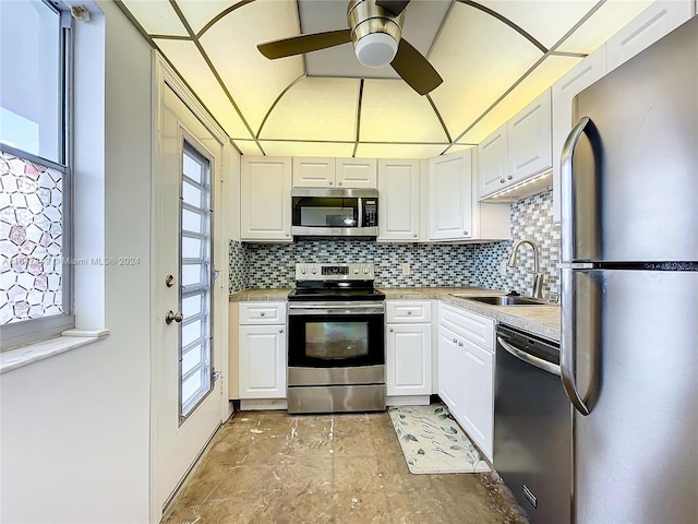 kitchen with sink, stainless steel appliances, ceiling fan, and white cabinets