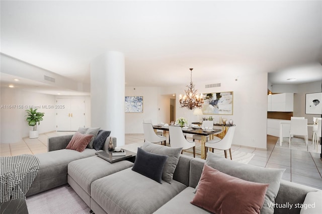 tiled living room featuring a chandelier