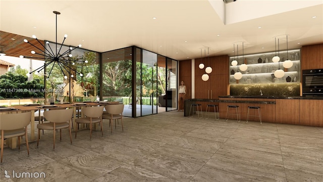 interior space with dobule oven black, a chandelier, decorative backsplash, floor to ceiling windows, and pendant lighting