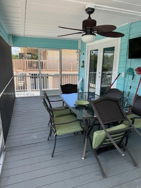 wooden terrace with ceiling fan and french doors