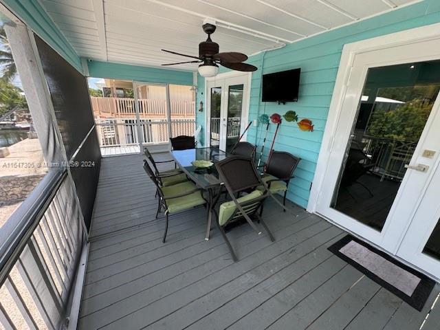 wooden deck featuring ceiling fan