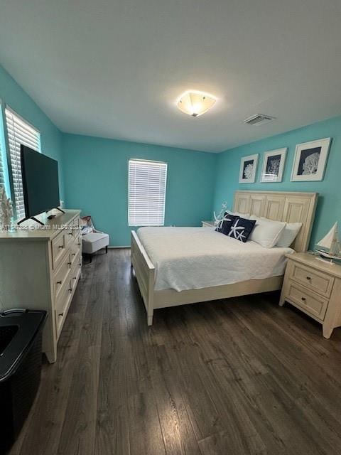 bedroom with dark wood-type flooring